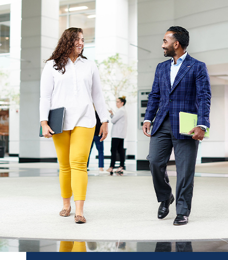 Two Brandoma Laboratory employees walking down the office hallway.