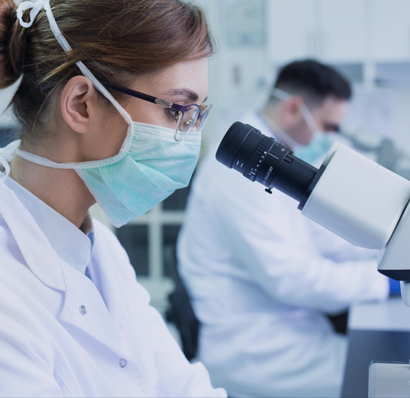 Female scientist looking into a microscope