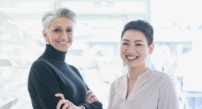 Two women smiling.